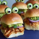 Halloween Monster Chicken Sliders with BBQ pulled chicken, guacamole, and cucumber olive monster eyes