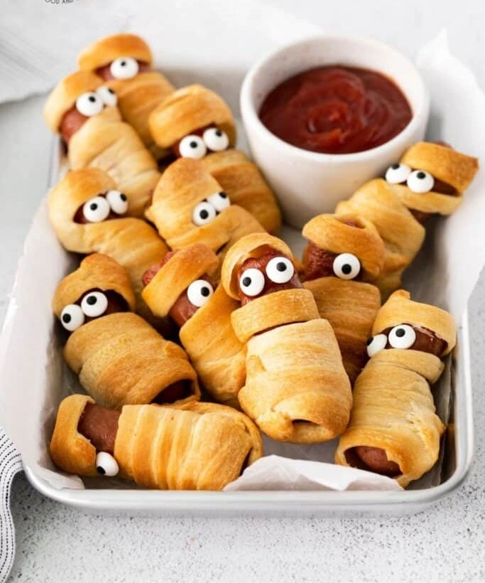 Mini Mummy Pigs in a Blanket made with crescent rolls and ketchup dip