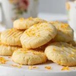 Freshly baked orange shortbread cookies with glaze and zest