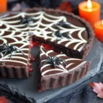 Spiderweb chocolate tart slice with Oreo crust and bloody caramel filling